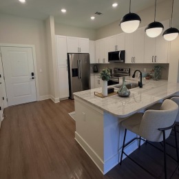 a kitchen with white cabinets